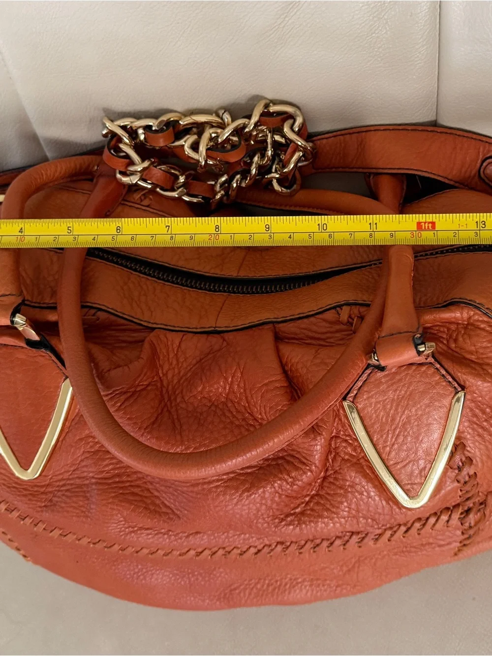 Orange leather handbag appears to be a slouchy style by orYany